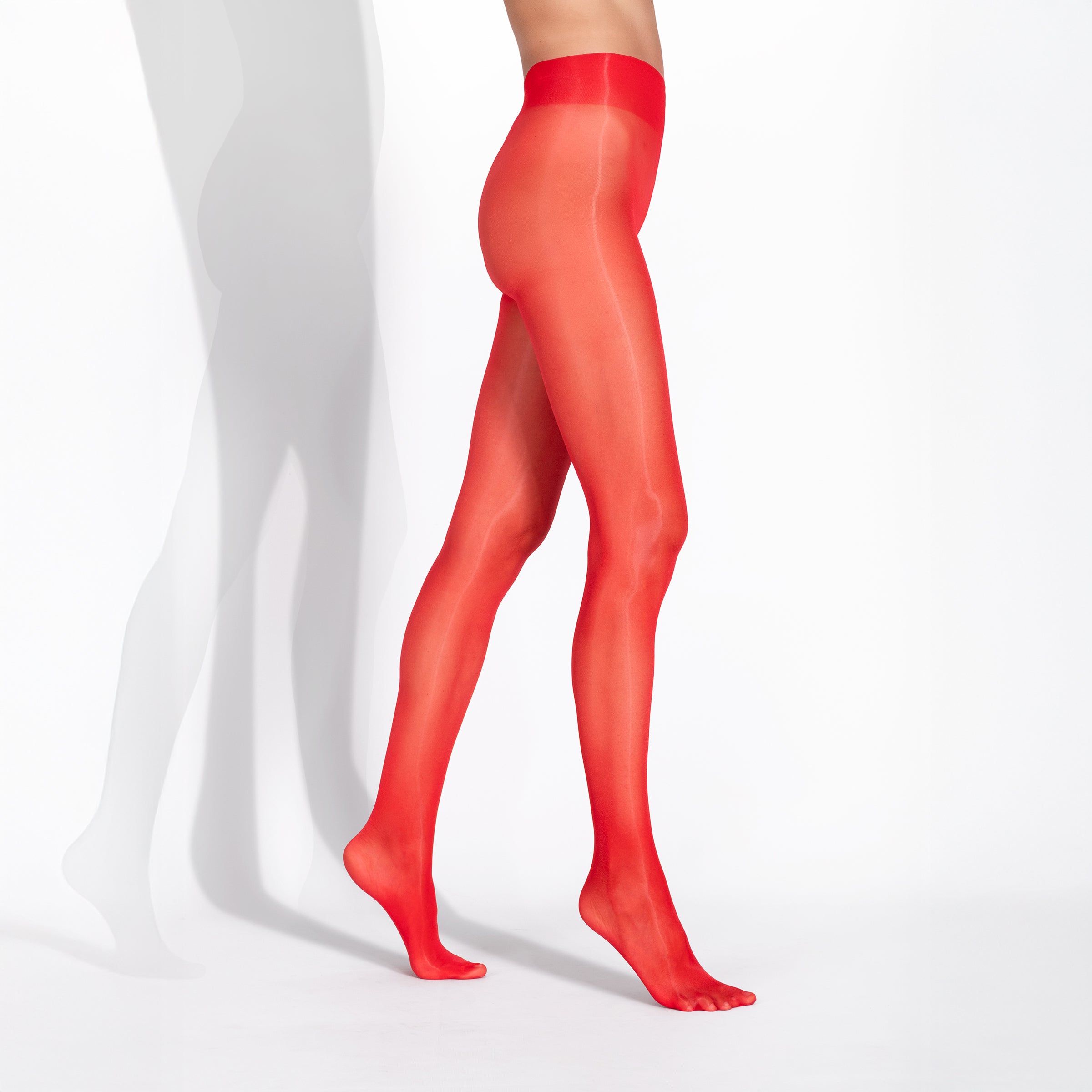 Red tights worn by a person on a white background