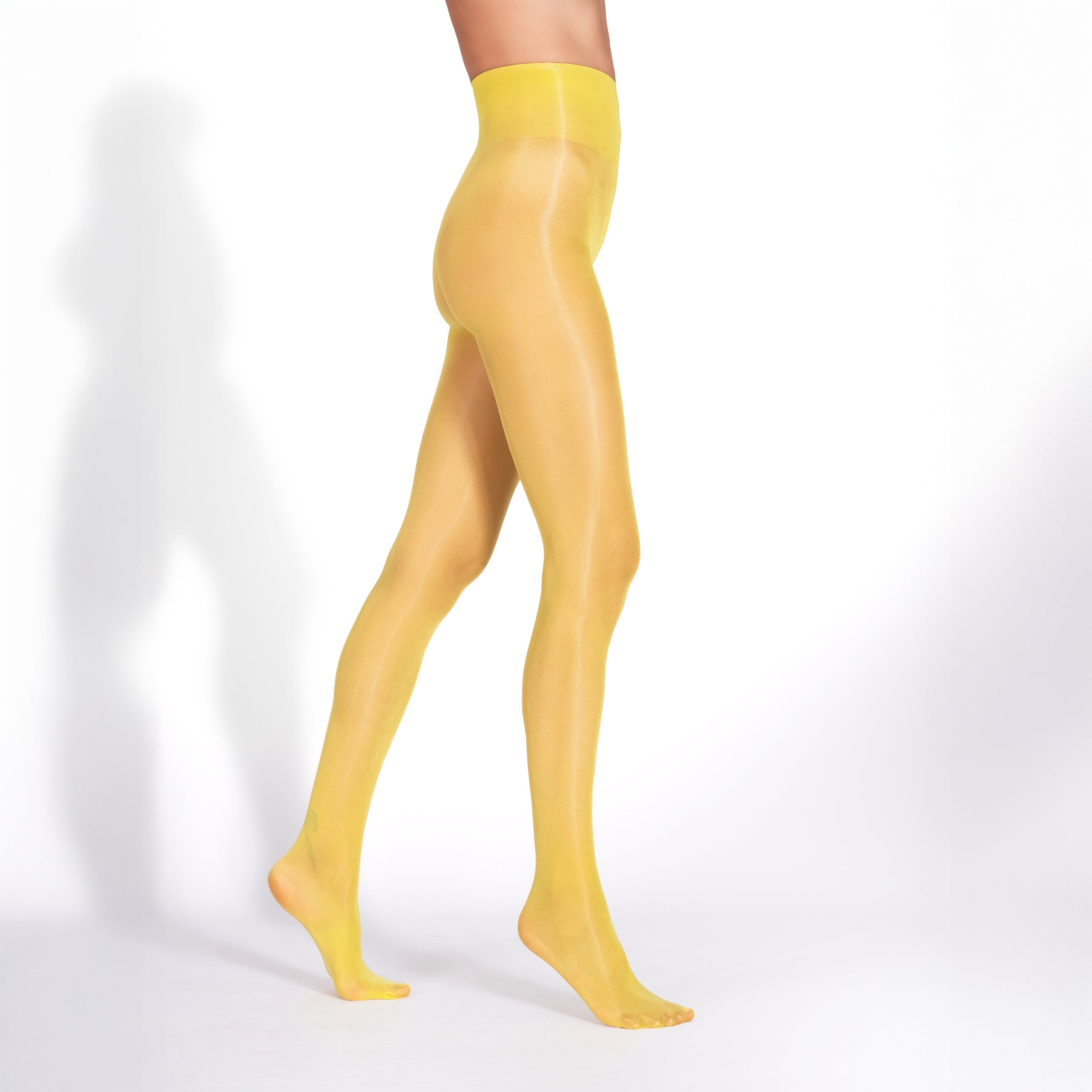 Yellow tights worn by a person on a white background