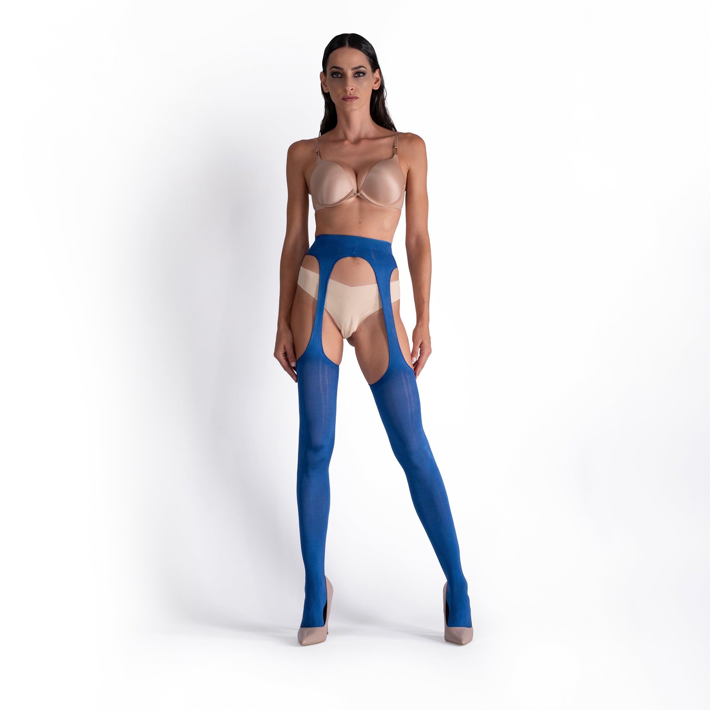 Woman wearing blue sheer stockings with cut-out design on a white background